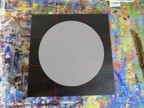 A digital representation of a gray circle on a black canvas with a red grid that divides the canvas into nine boxes. 